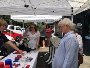 Community Educator explains about MainStreet services to passersby