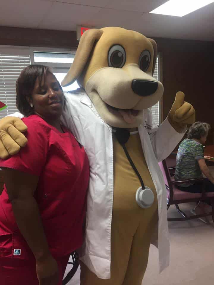 MainStreet Mascot hugs a nurse from Crowne 