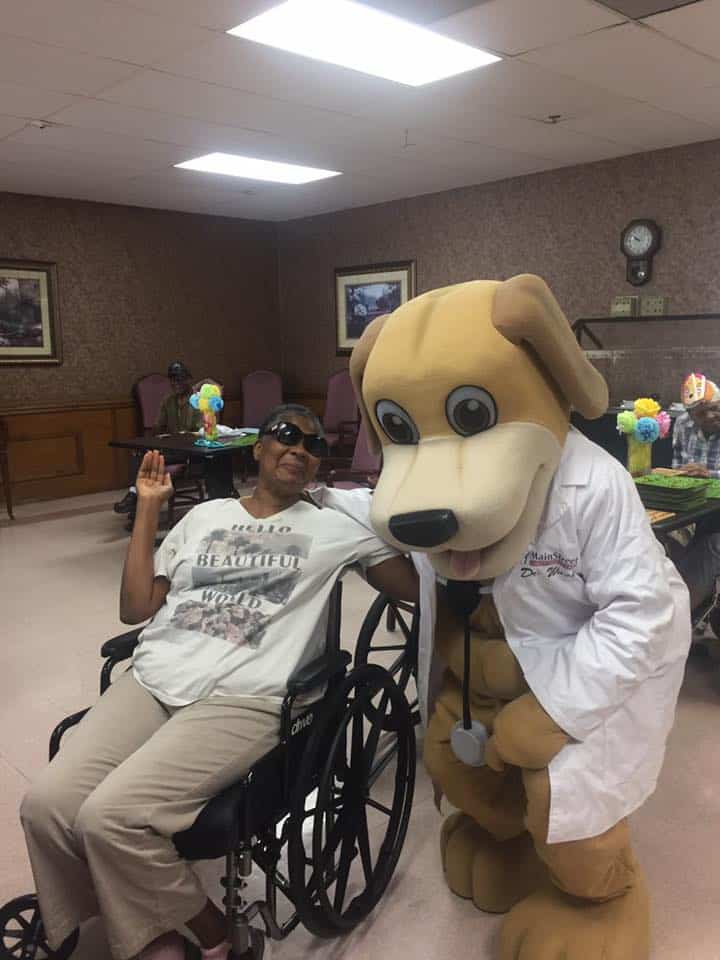 MainStreet Mascot poses with elderly lady 