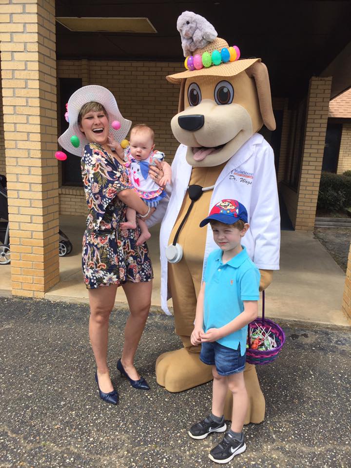 Community Educator and MainStreet Mascot take pictures with children at church on hwy 31 Spring