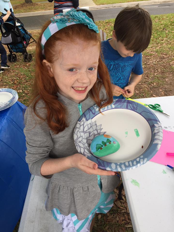 April events Pilgrimage kid paints rock at kids art tent