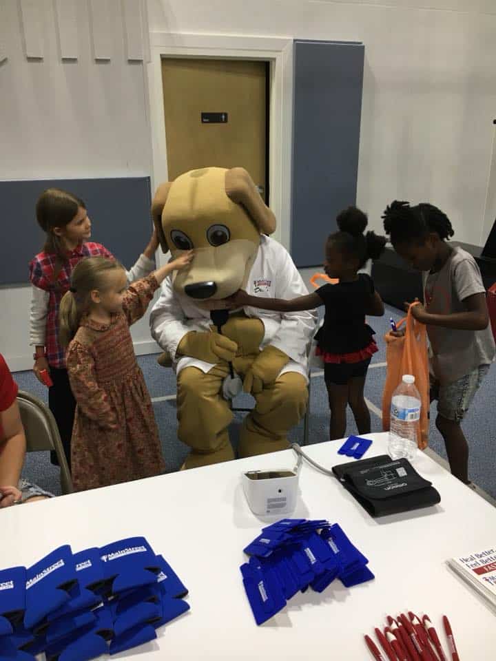 Kids at Health Fair at Boys and Girls Club Gym pet MainStreet Mascot Wags in May 