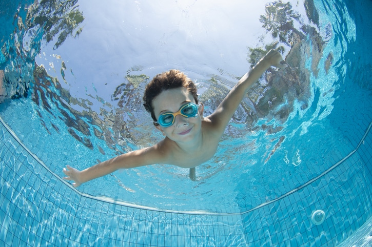 Underwater Young Boy Fun in the Swimming Pool with Goggles