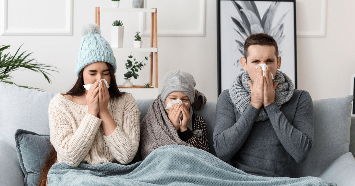 Family with flu sneezing