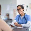 Nurse with a patient choosing between primary care vs. emergency room