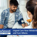 Man having his blood pressure checked at an urgent care clinic. Featured image for Urgent Care Near Winterville, Hull, and East Athens blog post.
